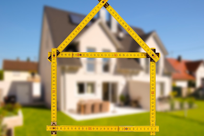 Contractor measuring roof by hand with spirit level