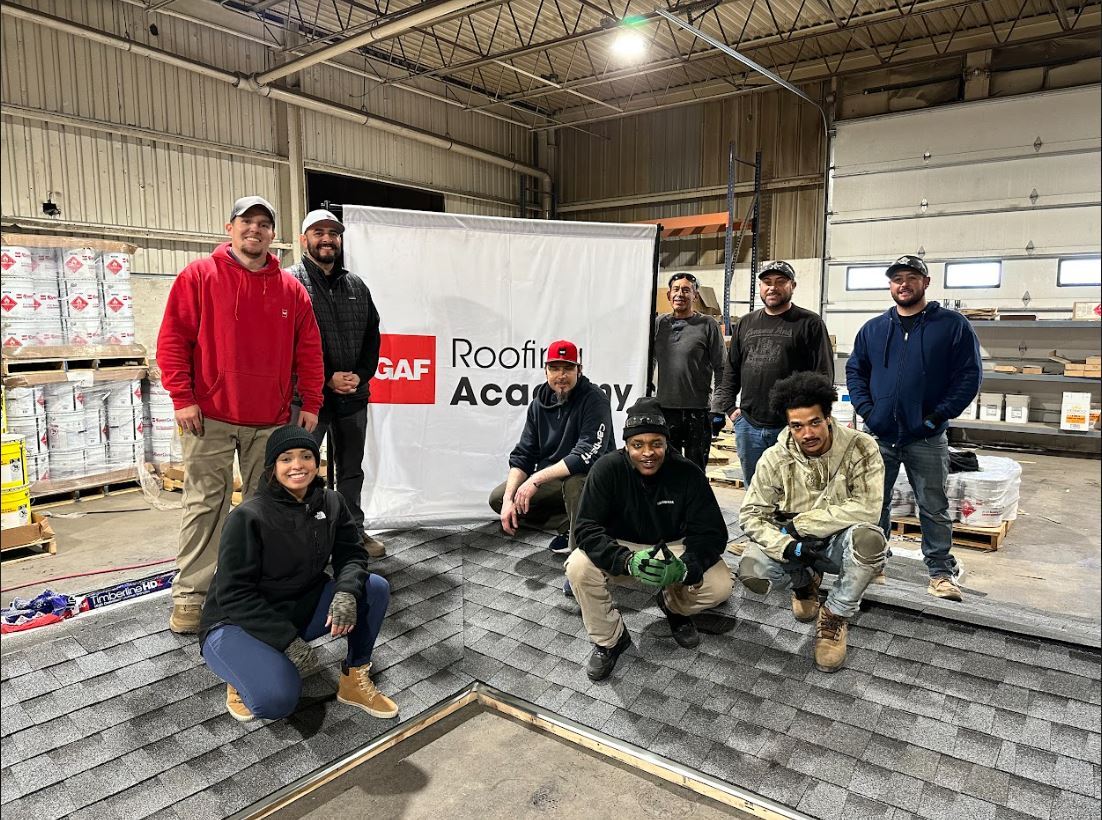 kimberly with a class on the roof Kimberly with her roofing Academy class on the roof