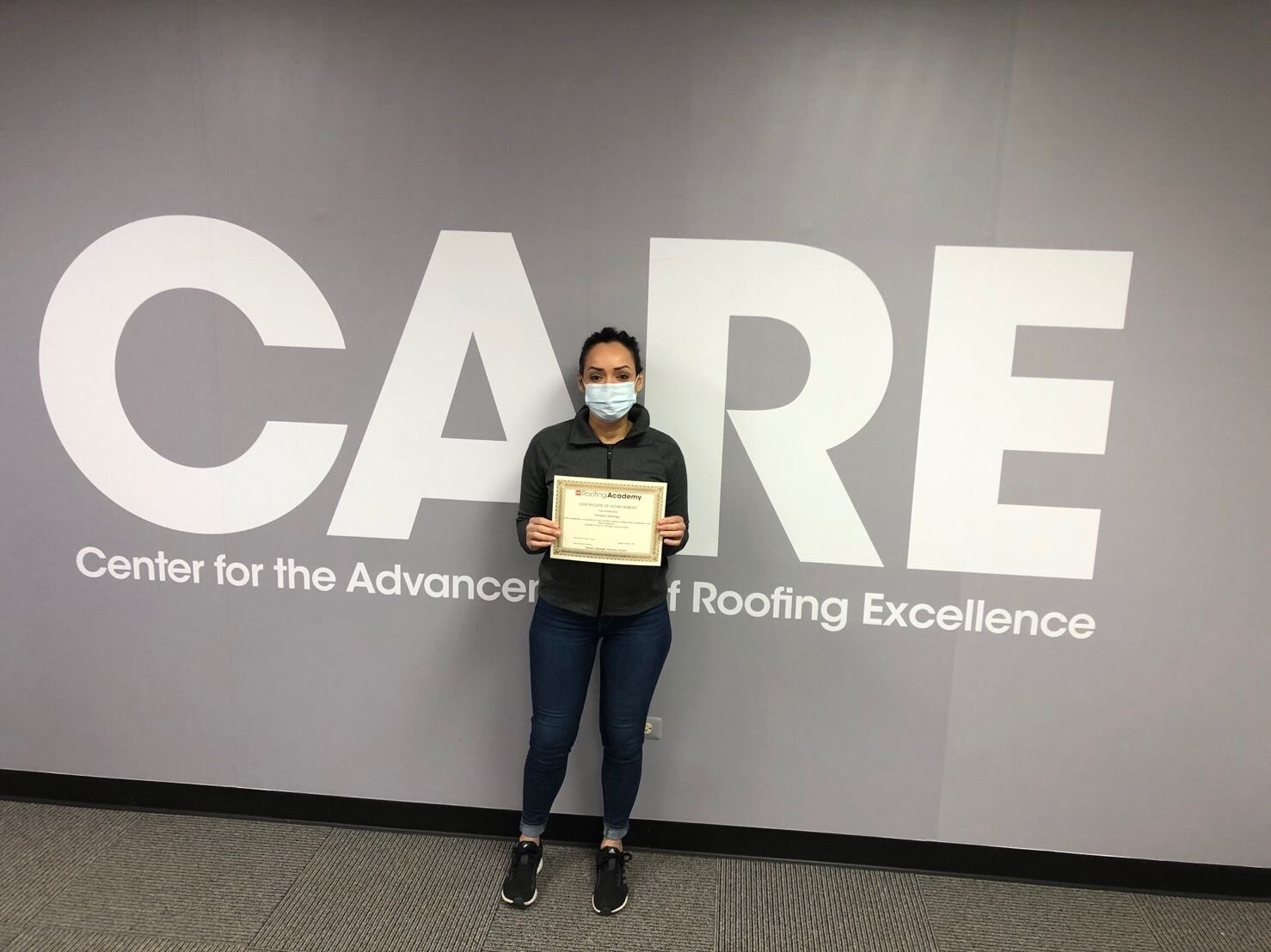 kimberly santiago care training Kimberly standing with GAF CARE certificate