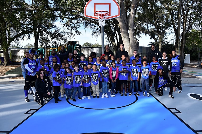 GAF worker applies StreetBond®, a solar-reflective pavement coating, to an asphalt court.