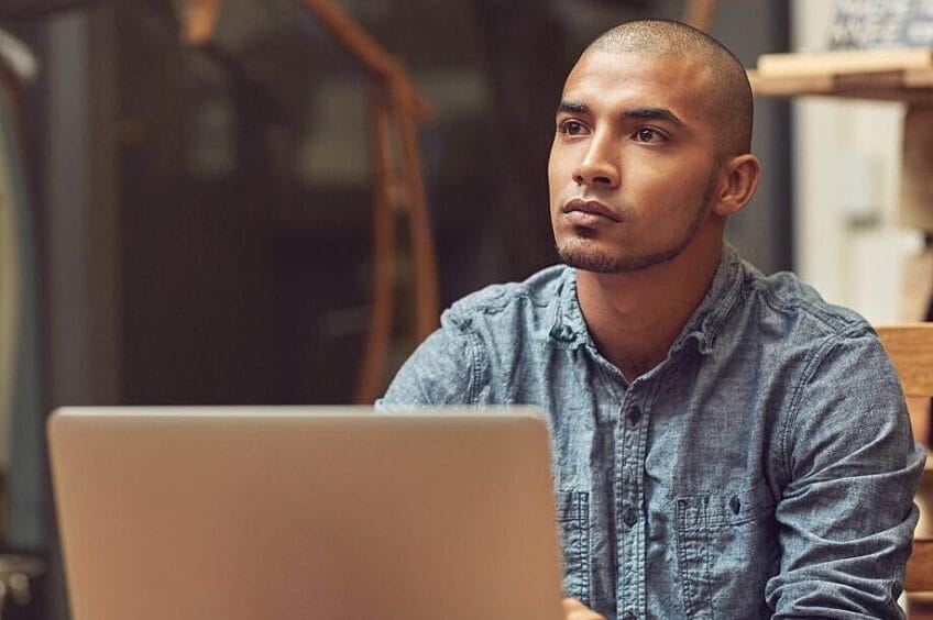 Man in chambray shirt at laptop