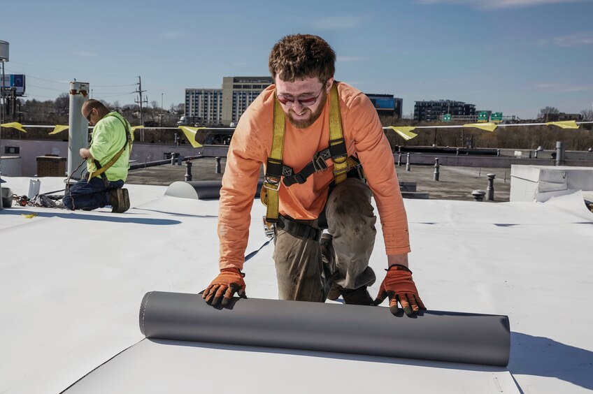 Contractor installing a commercial roof