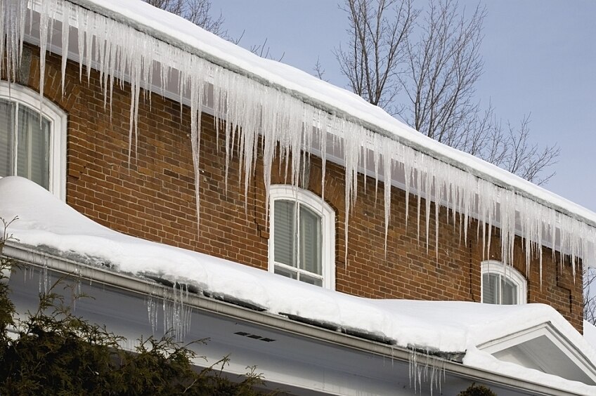 Icicles hanging on the edge of a roof.