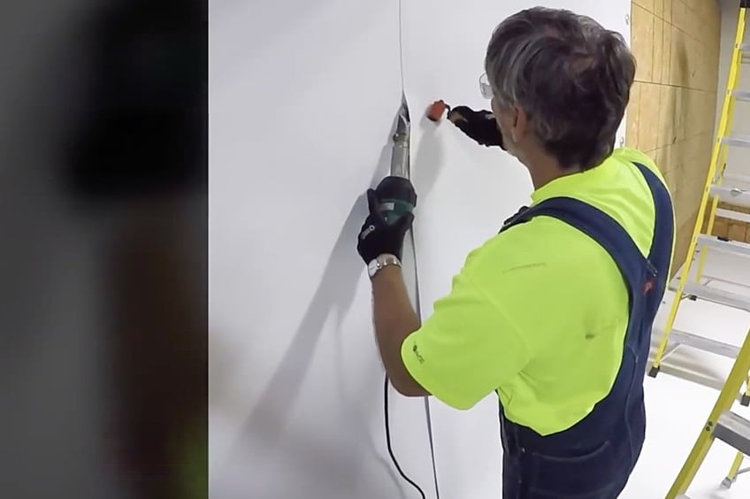 Contractor using roller and hand welder