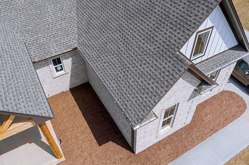 The corner of a roof made of asphalt shingles