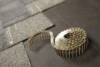 A coil of roofing nails on a new roof in progress
