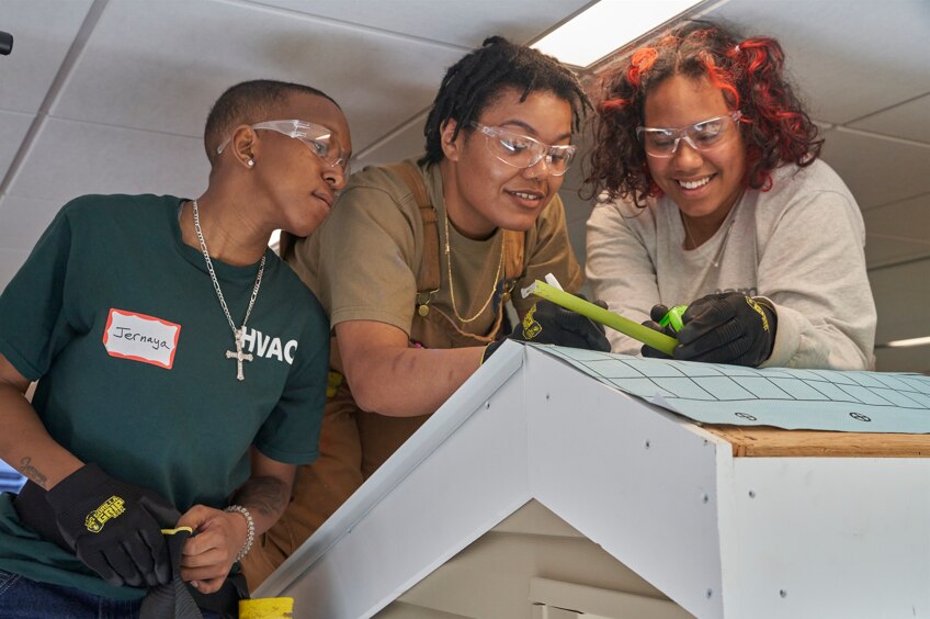 Shakyra at work training with Roofing Academy classmates