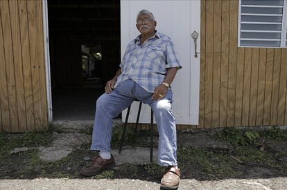 A Puerto Rico resident outside of his home being repaired by GAF and Team Rubicon