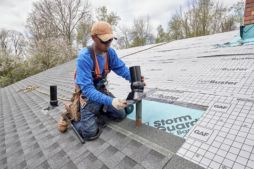 A roofer installs the GAF Master Flow™ Pivot™ Pipe Boot Flashing