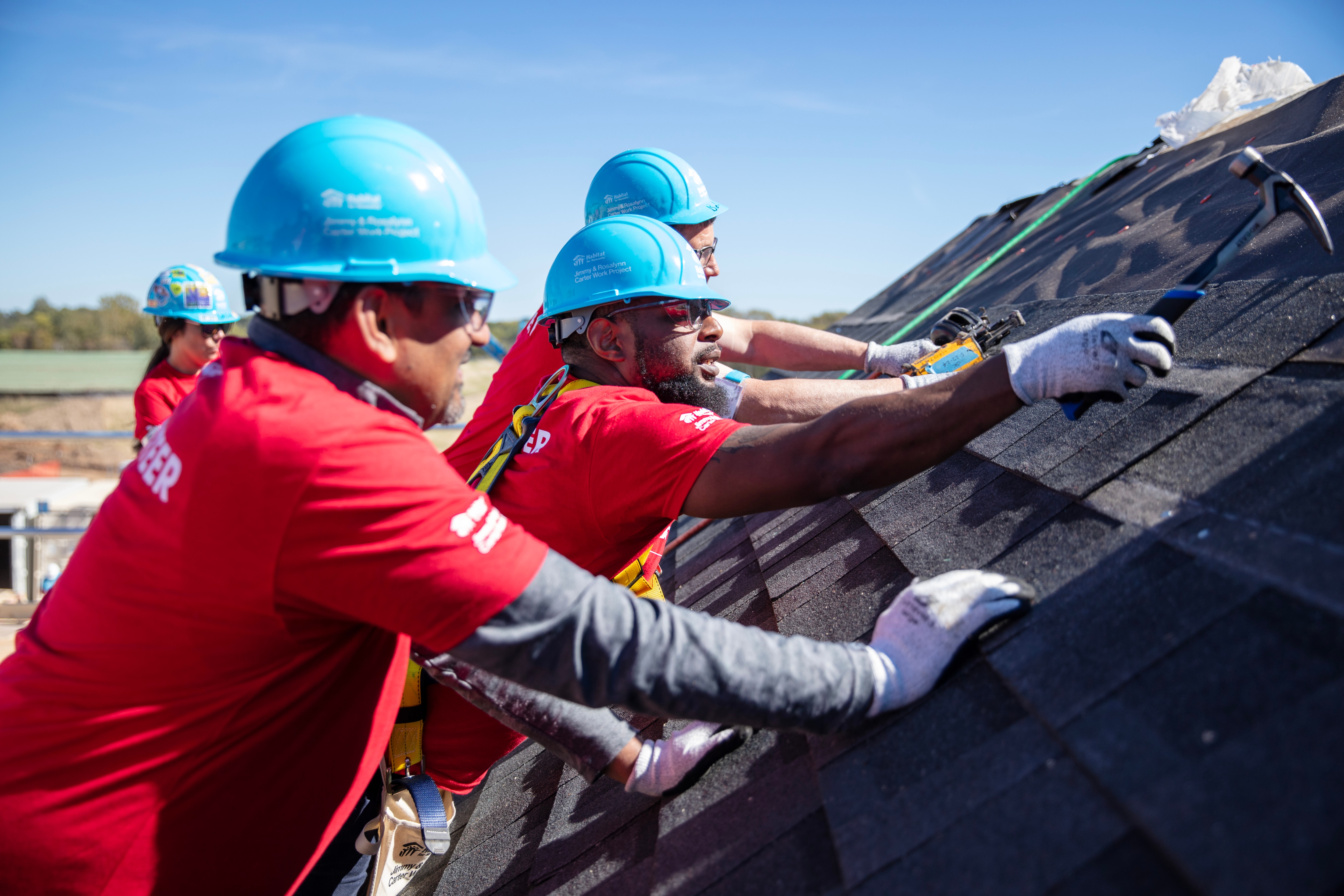 2024 carter work project volunteers, installing gaf solar shingles.