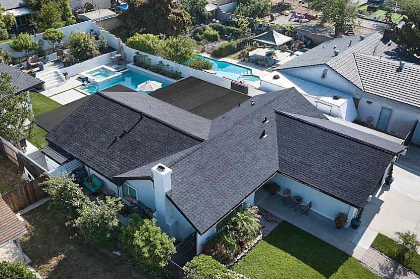 A large house with dark roofing shingles.