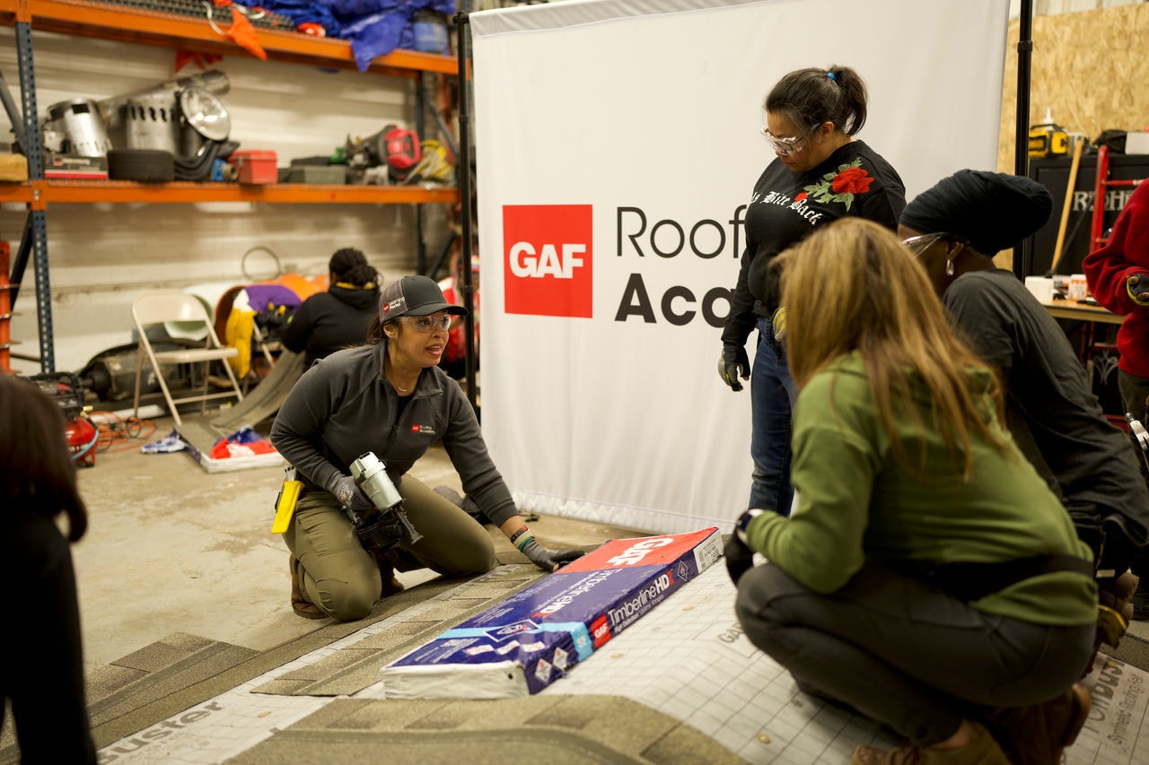 GAF Roofing Academy female instructor empowering women trainees in the roofing industry.