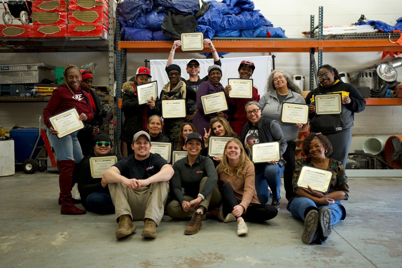 Female graduates of the GAF Roofing Academy program, a free roofer training program.