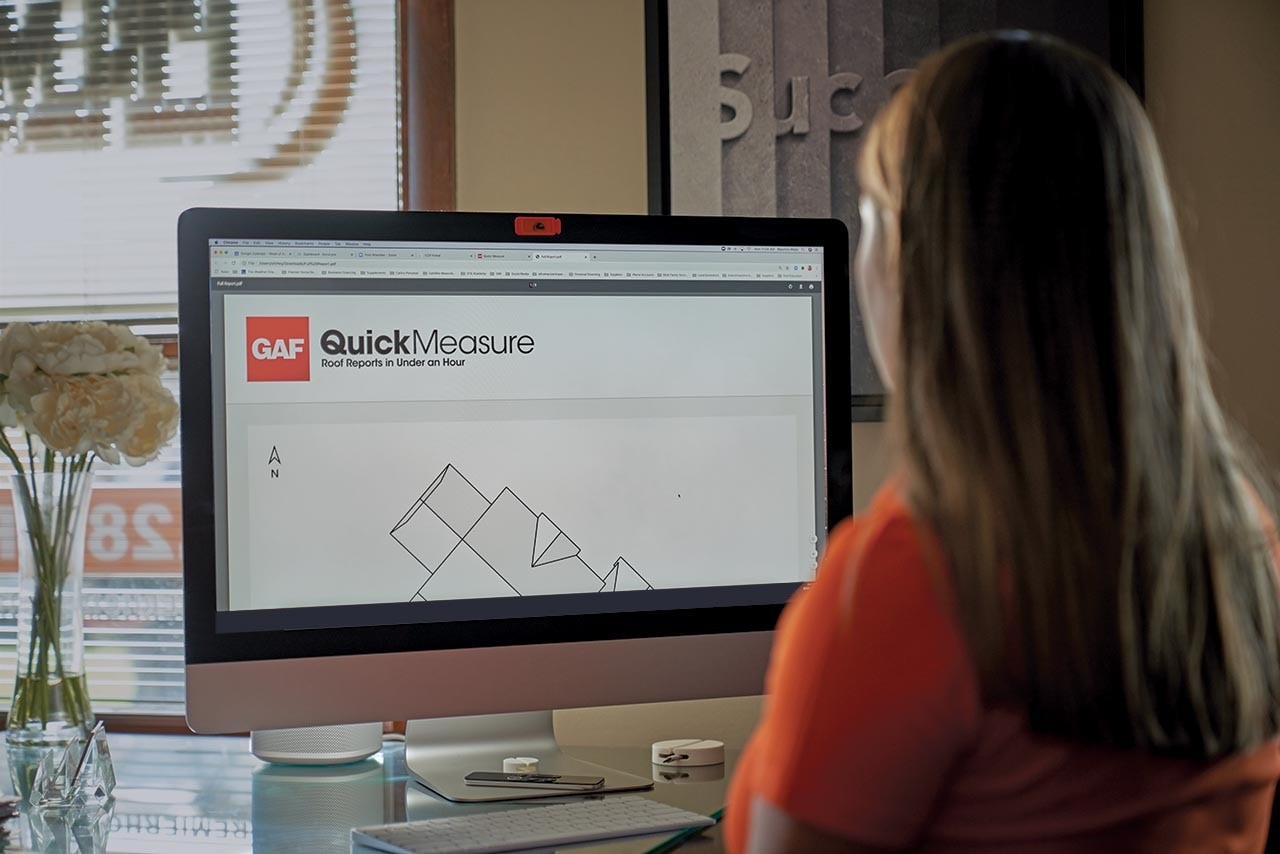 Residential Roofing Contractor Reviewing Specs Provided by GAF's QuickMeasure Tool