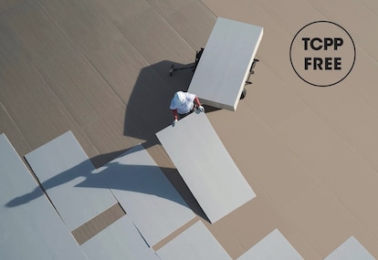 Roofers installing tcpp-free polyiso insulation.