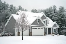 Winter house with woods in snow storm           