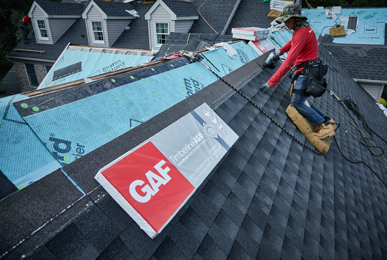 roofer installing gaf timberline as ii shingles on a roof Roofer Installing GAF Timberline AS II Shingles on a Roof