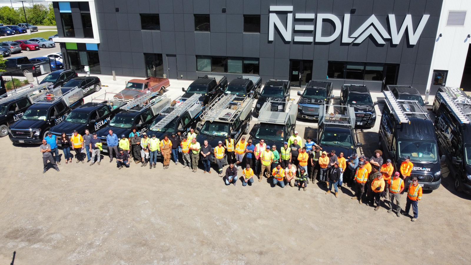 the nedlaw roofing team in front of their new corporate building The Nedlaw Roofing Team in front of their new corporate building