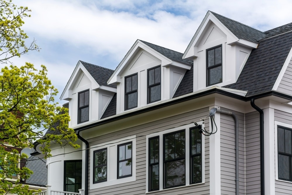 Contemporary house exterior featuring gray siding and black-framed windows in Boston, Massachusetts, USA Contemporary house exterior featuring gray siding and black-framed windows in Boston, Massachusetts, USA