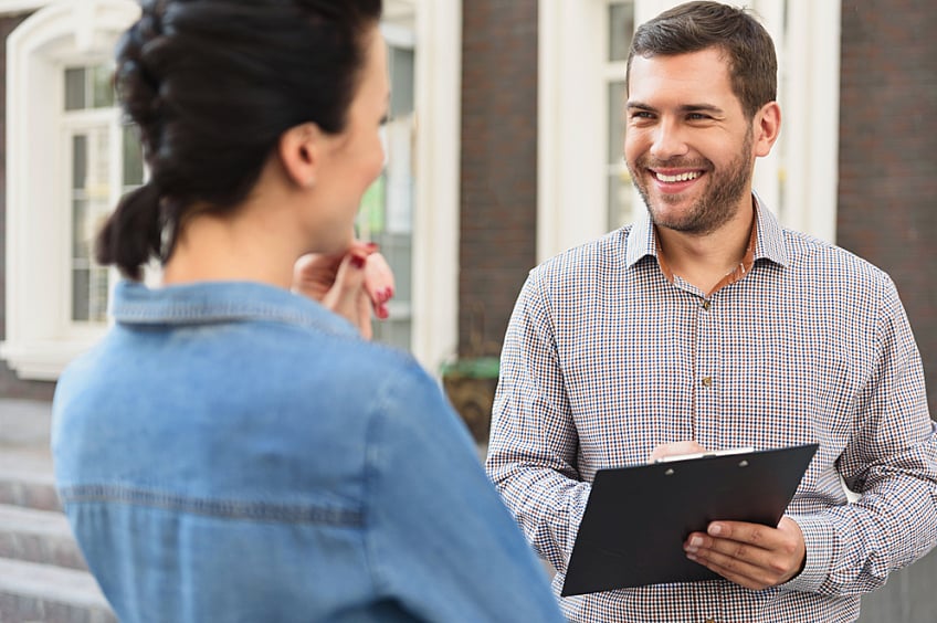 A contractor reviewing a roofing estimate with a homeowner