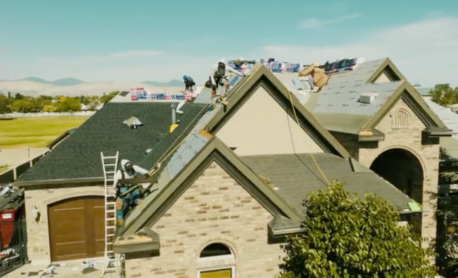 Roofers installing GAF Timberline HDZ® shingles on a residential home to ensure durability against harsh Utah canyon winds and UV exposure.