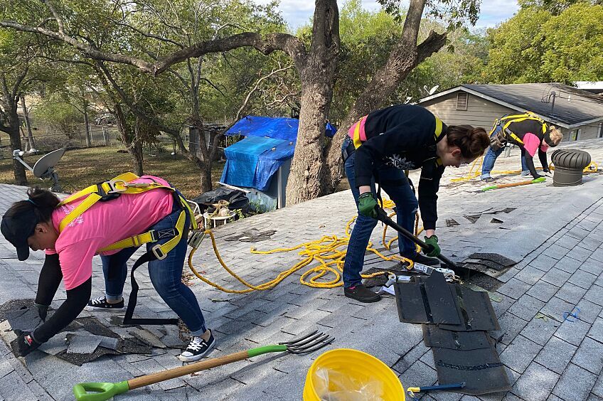Women installing a residential roof