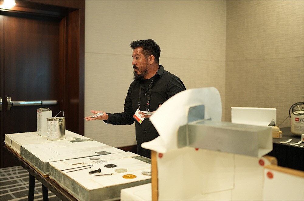 an instructor presenting at the gaf latinos in roofing expo An Instructor Presenting at The GAF Latinos in Roofing Expo