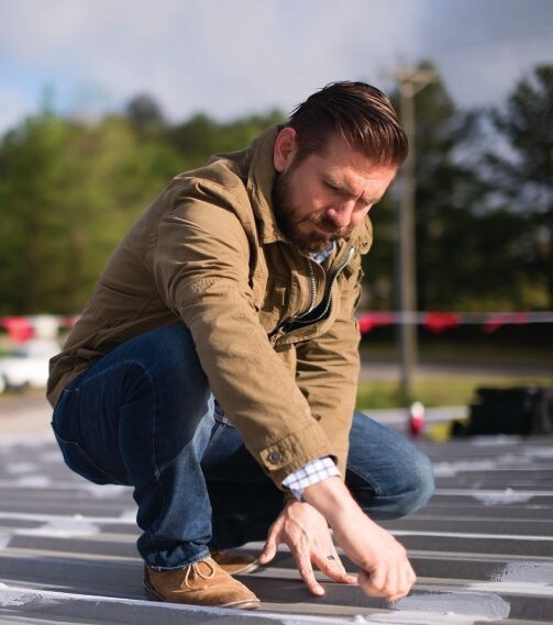 A contractor checking metal seam treatment.