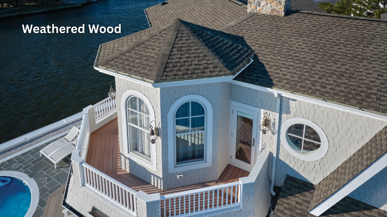 dad8dd35-6ed6-48e3-9ebc-4aa207d577e3 GAF Timberline UHDZ Shingles in the color Weathered Wood on the roof of a waterfront home.