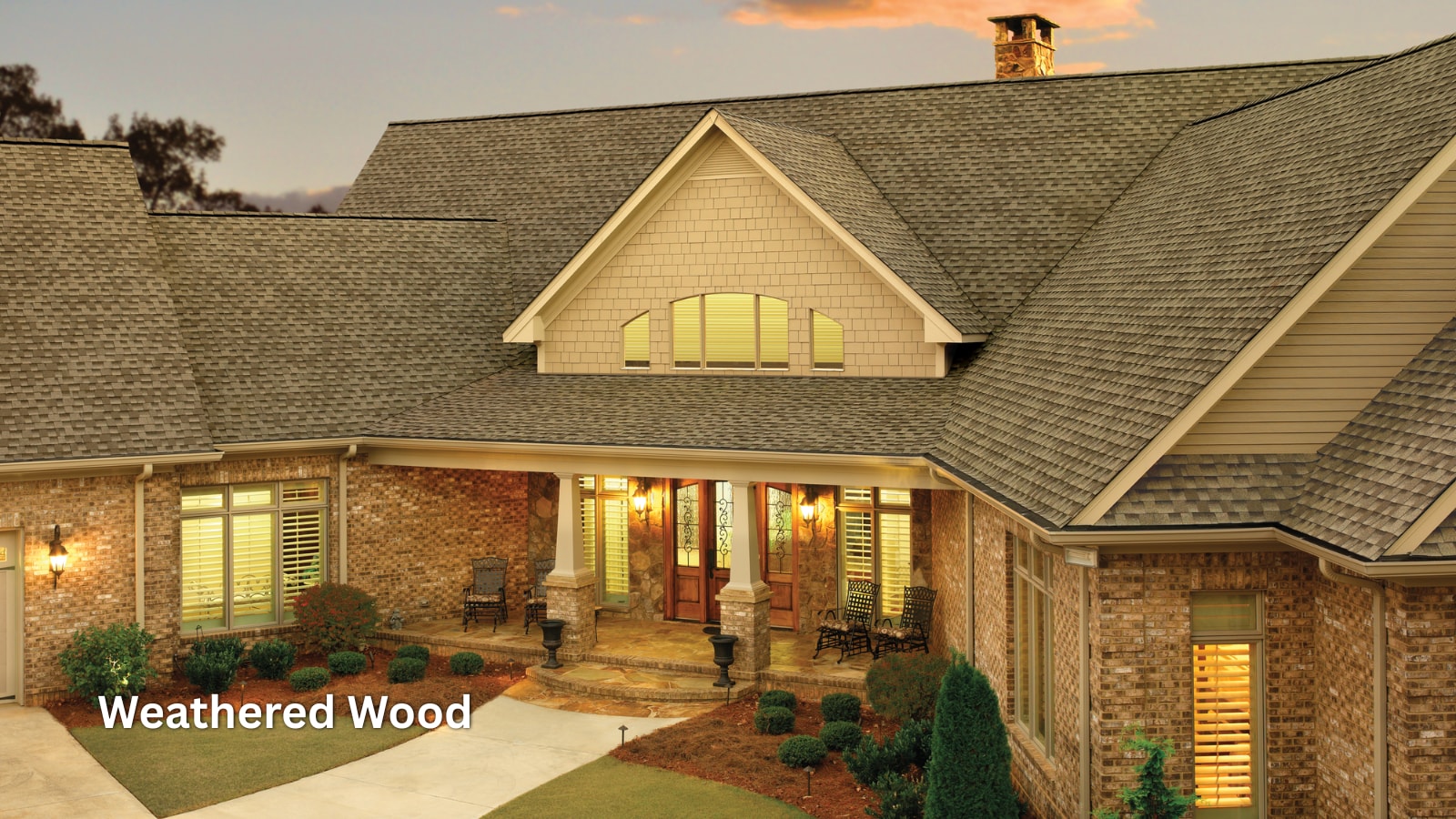 f5cfaccb-9388-404c-850e-d4af6a9c0a0c GAF Timberline HDZ shingles in the color Weathered Wood on the roof of a brick home.
