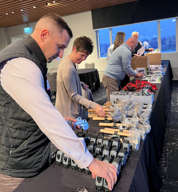 A table full of new homeowner tools is set up for new homeowner kits to be created by GAF Employees and Contractor Partners
