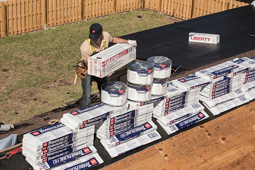 Two contractors working on a roof
