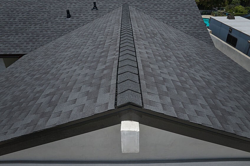 Contemporary house exterior featuring dark reflective shingles.