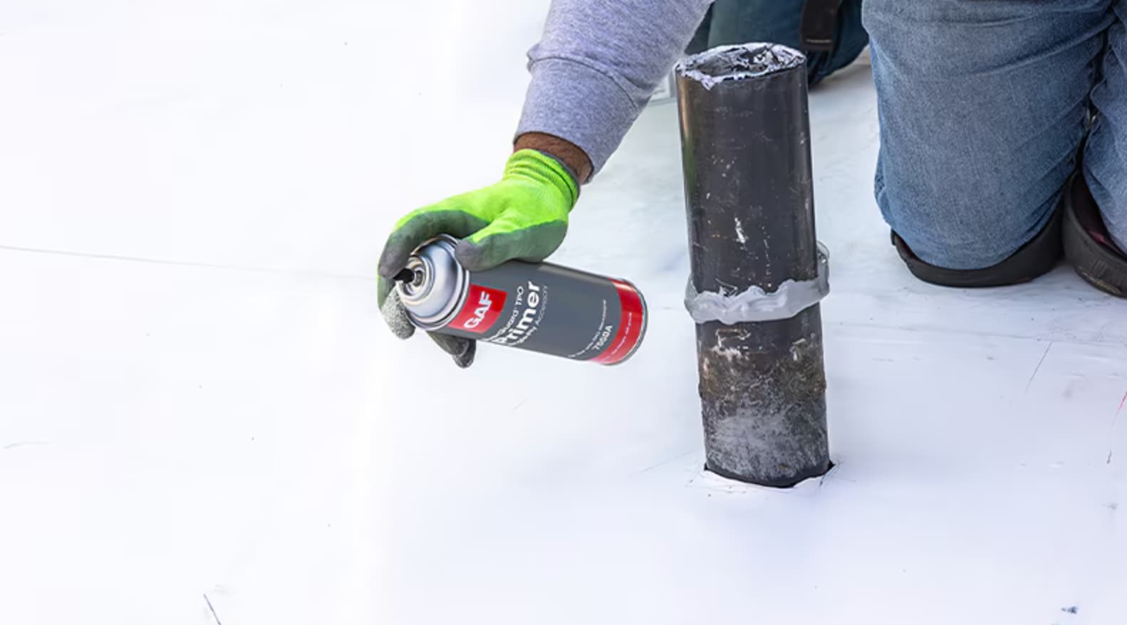 roofer using the gaf repair kit on a commercial roof Roofer using the GAF Repair Kit on a Commercial Roof