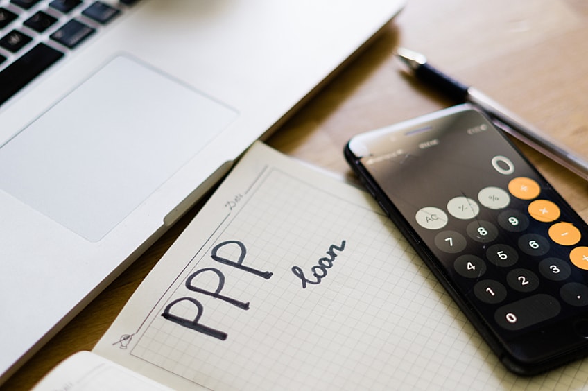 Calculator and notepad saying Paycheck Protection Program