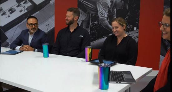 A construction worker reviews building design team inputs on a job site.