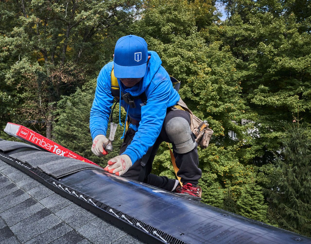 8ccdf83b-0aac-43f7-8434-7389a166bc8c Finish installing roofing shingles with the ridge cap