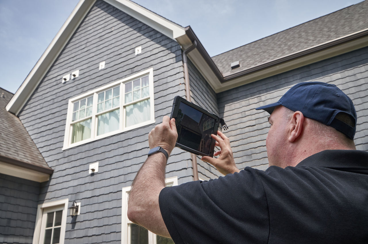 Contractor Filming the Roof of a Home using Horizontal Video Format