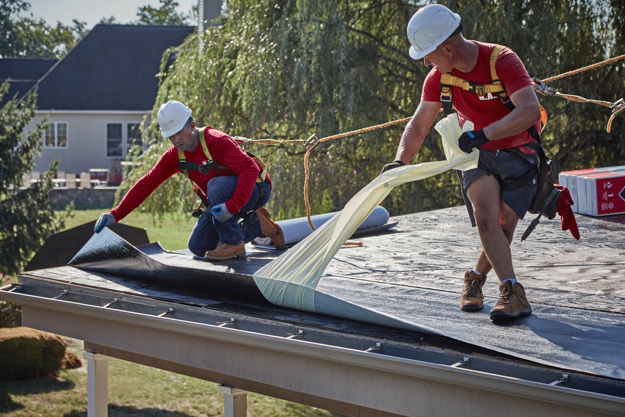 the LIBERTY™ Self-Adhering Base/Ply sheet is installed by rolling it out and peeling off the release film