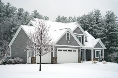 Winter house with woods in snow storm
