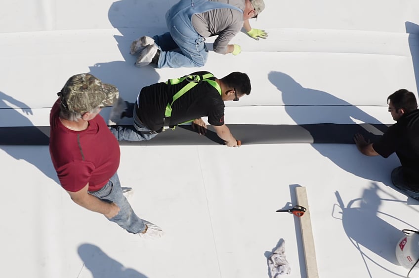 CARE crew installing a TPO Membrane