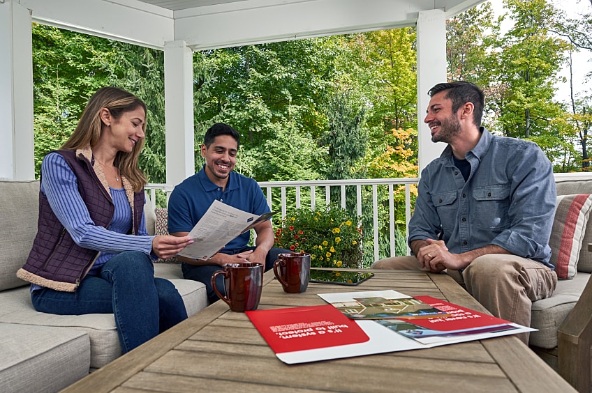 Couple discussing home insurance with agent.