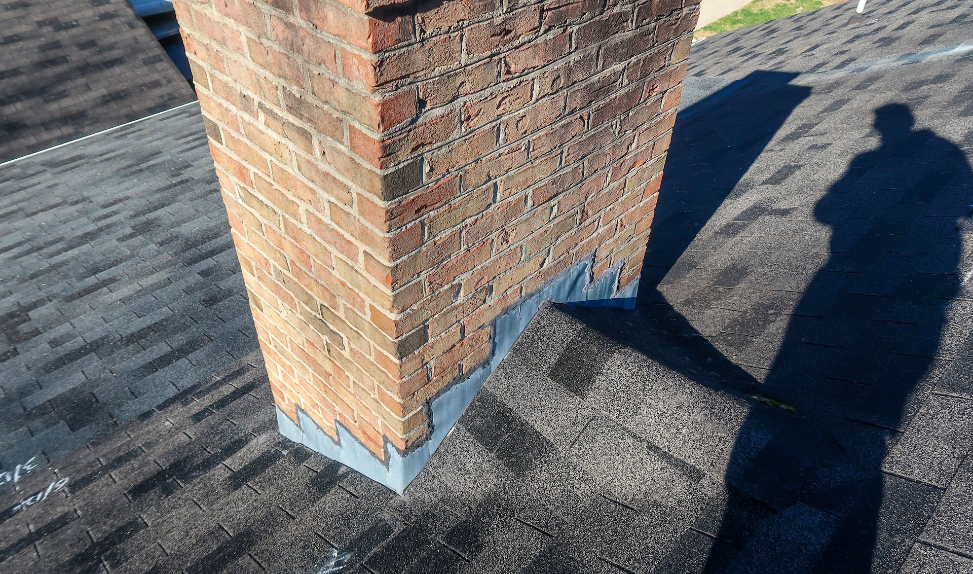 A roof cricket: the triangular structure installed behind a chimney, skylight, or other roof protrusion to help divert water.